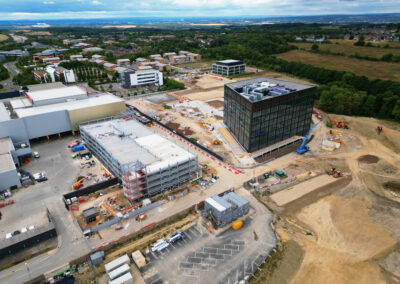 Striking drone photo of a new building and multi storey car park.